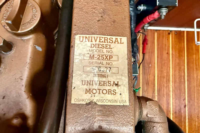 Slide: The Image of Universal Diesel engine label on a 1988 Catalina 36 sailboat, model M-25XP. - 38