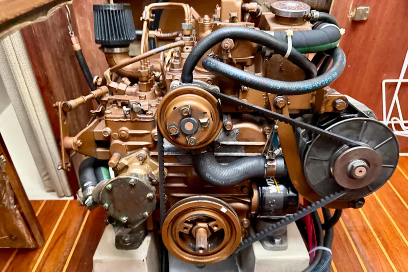 Slide: The Image of Engine of a 1988 Catalina 36 sailboat, showcasing mechanical components and belts. - 39