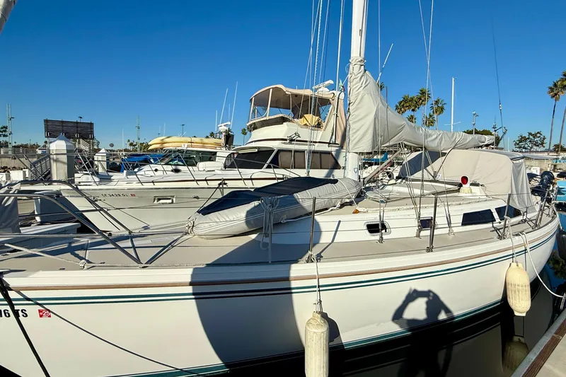 Slide: The Image of 1988 Catalina 36 sailboat docked at marina under clear blue sky. - 4