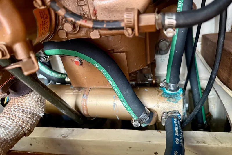 Slide: The Image of Engine compartment of a 1988 Catalina 36 sailboat, showing hoses and mechanical components. - 40