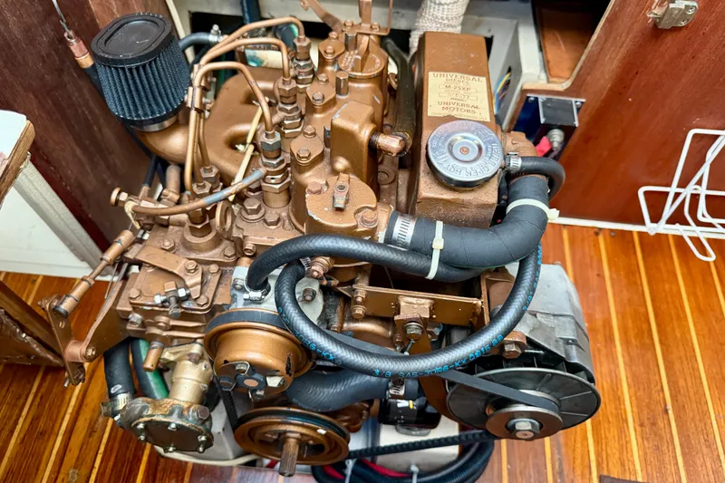 Slide: The Image of Engine of a 1988 Catalina 36 sailboat, showcasing detailed components and hoses. - 41