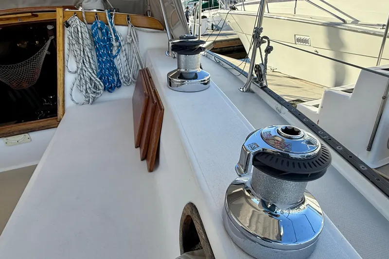 Slide: The Image of 1988 Catalina 36 sailboat deck with winches and coiled ropes. - 8
