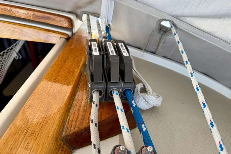Slide: The Image of Rope clutches on a 1988 Catalina 36 sailboat, labeled for main sheet and halyards. - 9