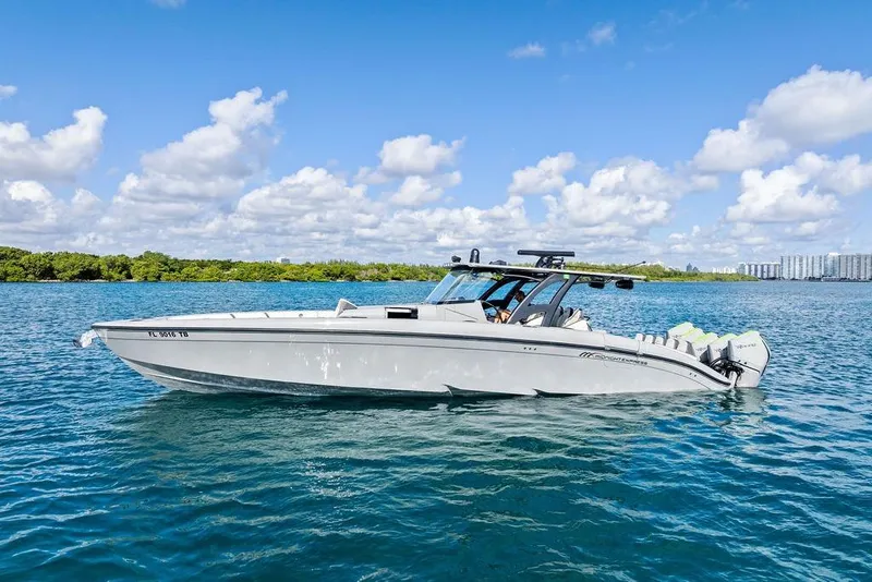 Slide: The Image of 2022 Midnight Express 43' Solstice boat on clear blue water under a sunny sky. - 12