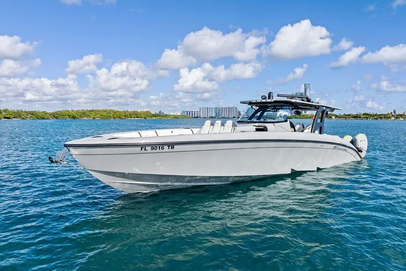 Slide: The Image of 2022 Midnight Express 43' Solstice boat on clear blue water under a sunny sky. - 13