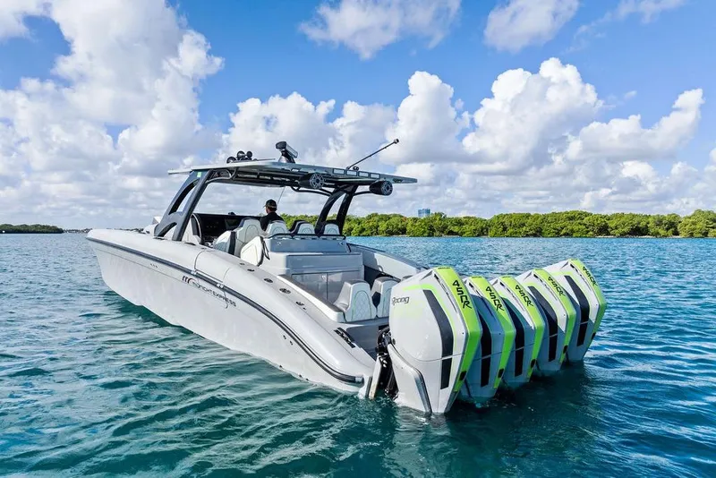 Slide: The Image of 2022 Midnight Express 43' Solstice boat with multiple engines on blue water. - 14