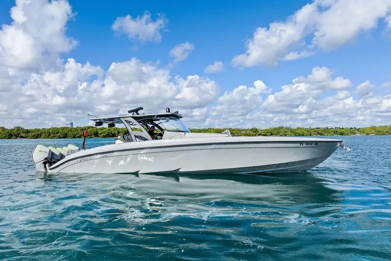 Slide: The Image of 2022 Midnight Express 43' Solstice boat on clear blue water under a bright sky. - 18