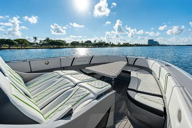 Slide: The Image of Luxurious 2022 Midnight Express 43' Solstice boat interior with seating and table, on a sunny day. - 25