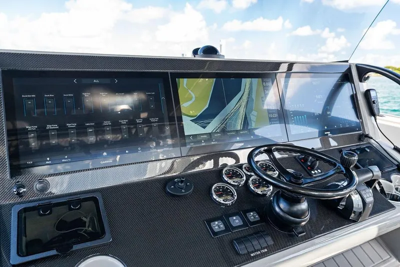 Slide: The Image of Dashboard of 2022 Midnight Express 43' Solstice boat with advanced navigation displays. - 39
