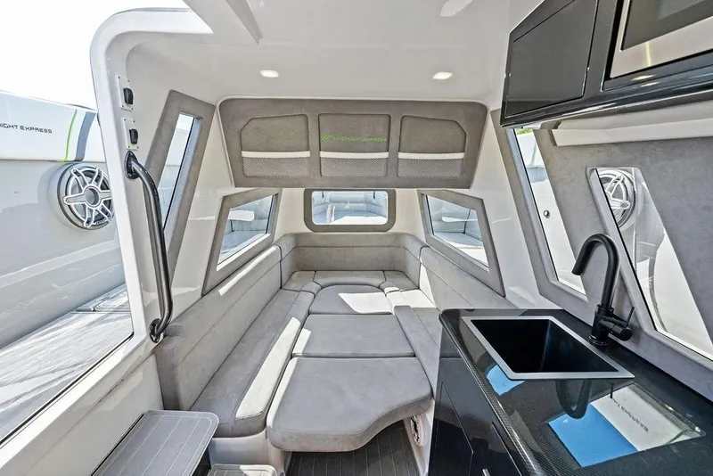 Slide: The Image of Luxurious interior of 2022 Midnight Express 43' Solstice boat with modern seating and kitchenette. - 43