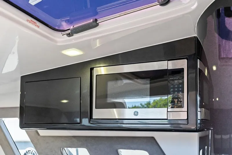 Slide: The Image of Modern kitchen area in 2022 Midnight Express 43' Solstice boat with built-in microwave. - 45
