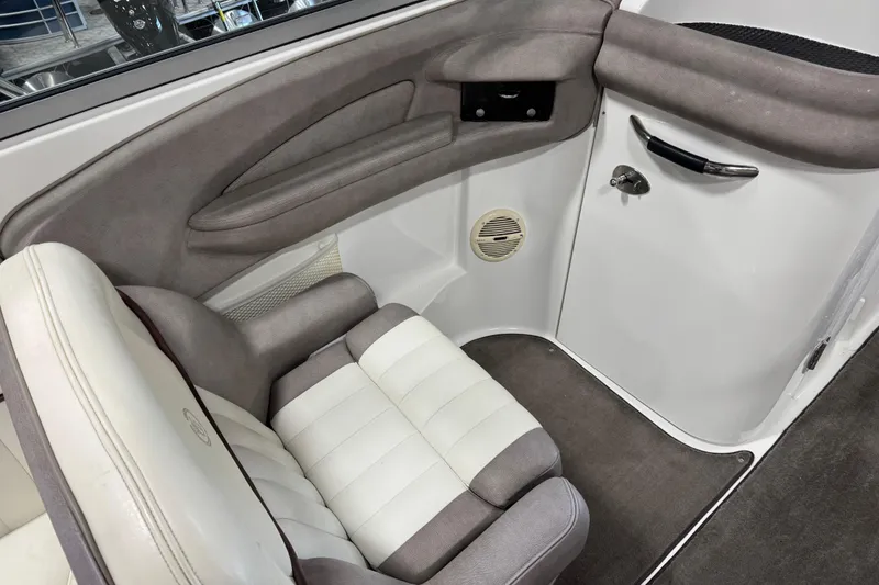 Slide: The Image of Interior of a 2005 Cobalt 282 boat, featuring a cushioned seat and sleek design. - 10