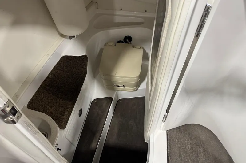 Slide: The Image of Interior of 2005 Cobalt 282 boat with compact toilet and carpeted flooring. - 12