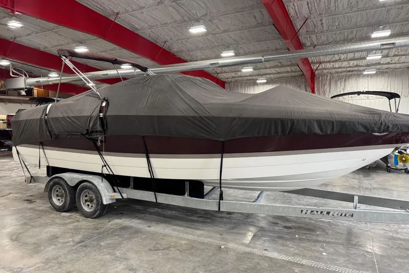 Slide: The Image of 2005 Cobalt 282 boat covered on trailer in indoor storage facility. - 13