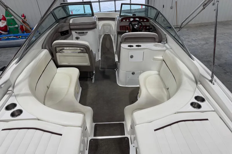 Slide: The Image of 2005 Cobalt 282 boat interior with white seating and modern dashboard design. - 6