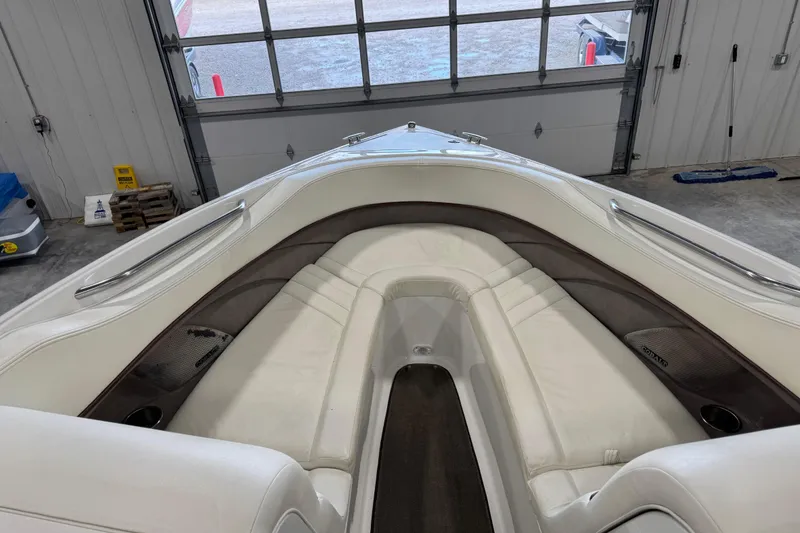 Slide: The Image of 2005 Cobalt 282 boat interior with white leather seating in a garage setting. - 9