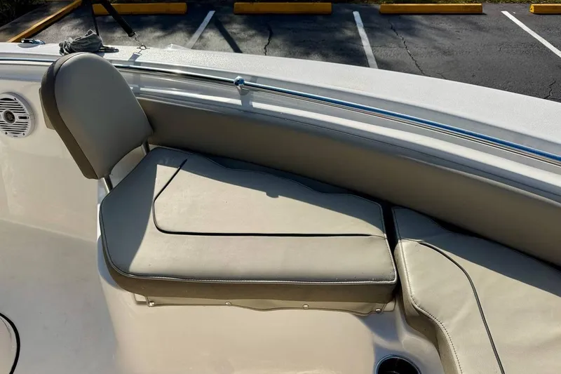Slide: The Image of 2023 Key West 219 FS boat interior seating with beige cushions. - 10