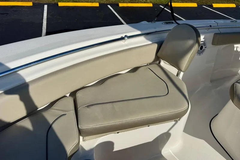Slide: The Image of 2023 Key West 219 FS boat interior with beige cushioned seating and stainless steel railing. - 11