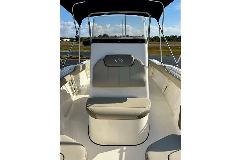 Slide: The Image of 2023 Key West 219 FS boat interior with cushioned seating and canopy. - 12