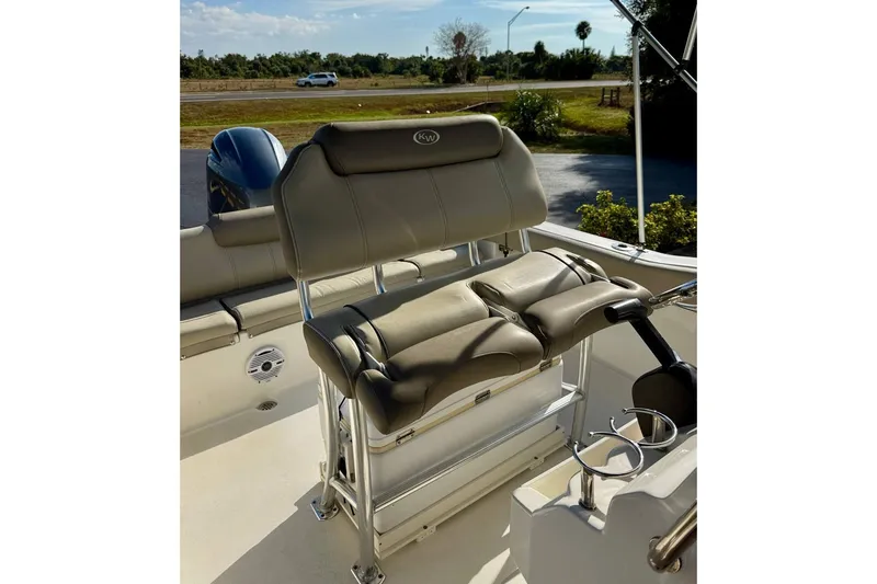 Slide: The Image of 2023 Key West 219 FS boat interior with cushioned seating and steering console. - 16