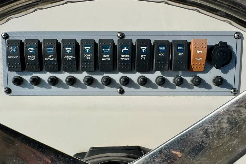 Slide: The Image of Control panel of 2023 Key West 219 FS boat with labeled switches and buttons. - 20