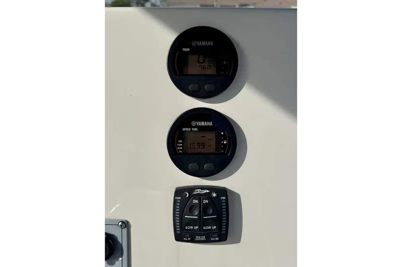 Slide: The Image of 2023 Key West 219 FS boat dashboard with Yamaha gauges and control panel. - 21
