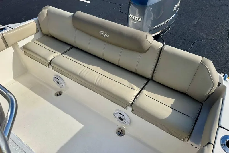 Slide: The Image of 2023 Key West 219 FS boat with beige seating and Yamaha 200 engine. - 24