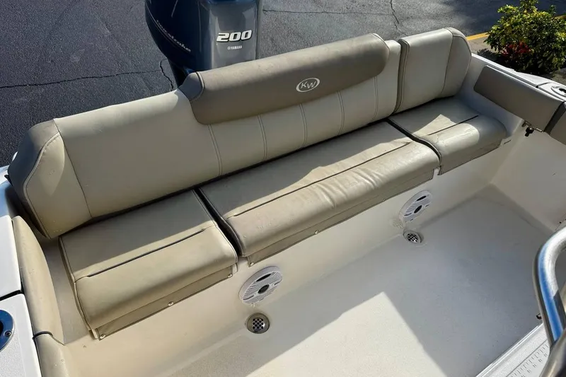 Slide: The Image of 2023 Key West 219 FS boat with beige seating and Yamaha 200 engine. - 26