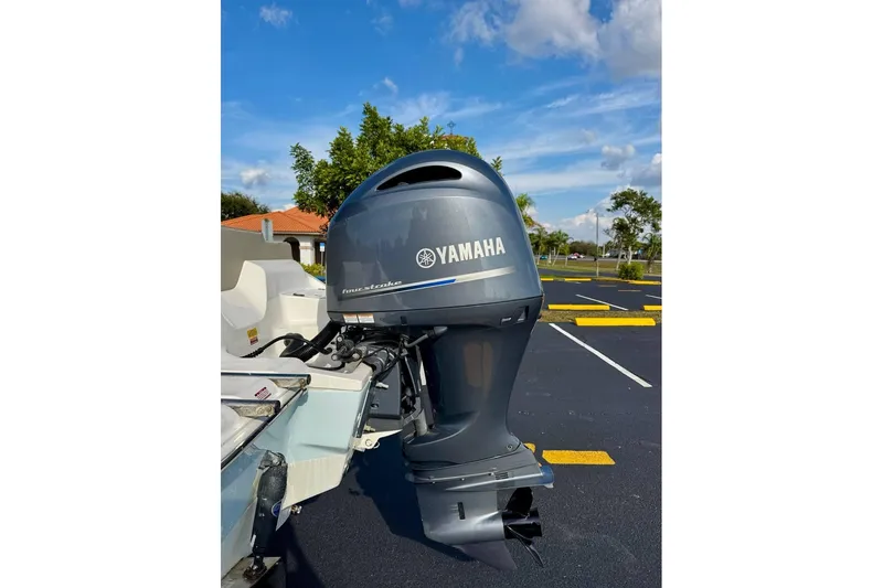 Slide: The Image of 2023 Key West 219 FS boat with Yamaha four-stroke outboard motor in parking lot. - 27