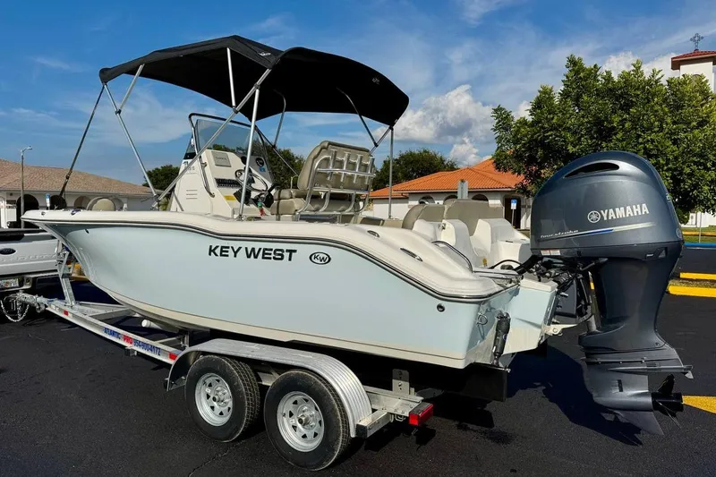 Slide: The Image of 2023 Key West 219 FS boat with Yamaha engine on trailer, parked outdoors. - 4