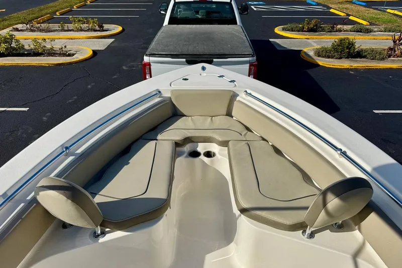 Slide: The Image of 2023 Key West 219 FS boat interior with seating, parked in a lot. - 9