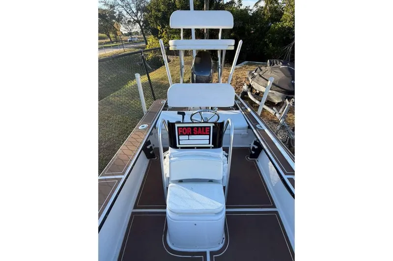 Slide: The Image of 1972 Hewes 17 Bonefisher boat with "For Sale" sign, white seating, and brown deck. - 3