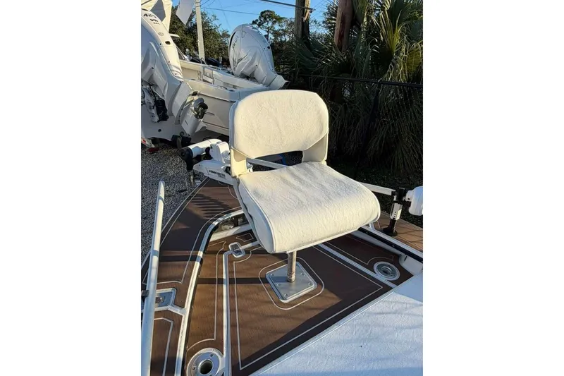 Slide: The Image of 1972 Hewes 17 Bonefisher boat seat on deck, featuring a white cushioned chair. - 6