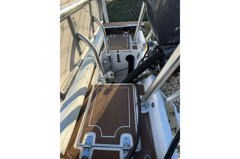 Slide: The Image of 1972 Hewes 17 Bonefisher boat interior with metal railings and engine components. - 9