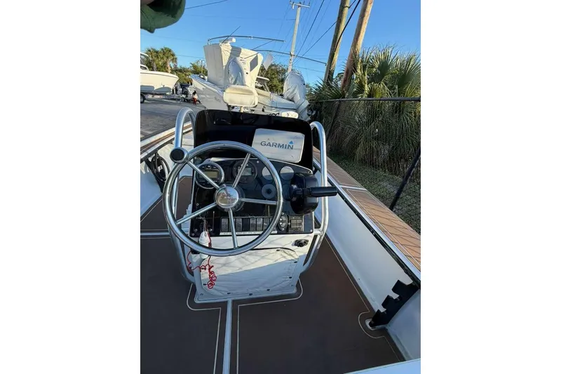 Slide: The Image of 1972 Hewes 17 Bonefisher boat cockpit with steering wheel and Garmin navigation system. - 5