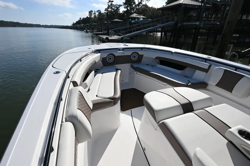 Slide: The Image of 2025 Tidewater 320 CC Adventure boat interior with luxurious seating and waterfront view. - 10