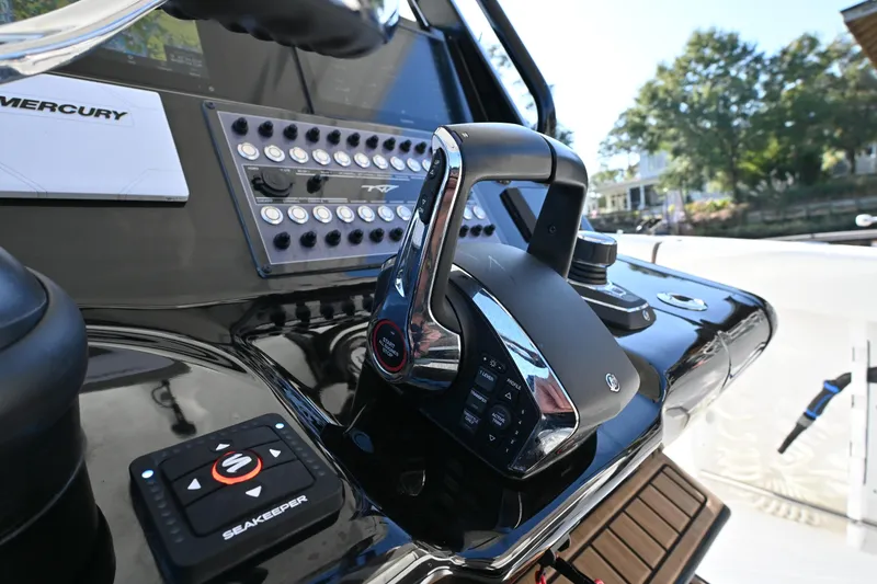 Slide: The Image of Close-up of 2025 Tidewater 320 CC Adventure boat controls and dashboard. - 15