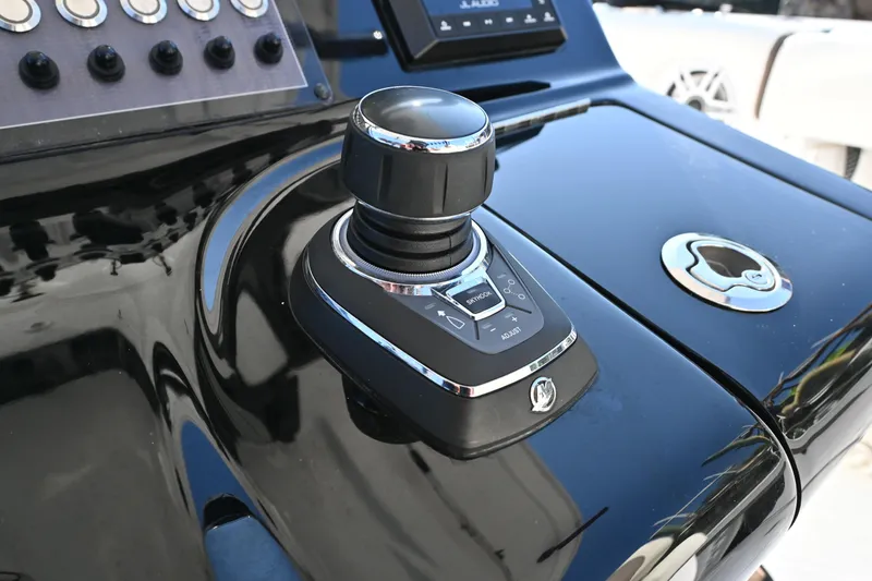 Slide: The Image of Control panel of 2025 Tidewater 320 CC Adventure boat with joystick and buttons. - 16
