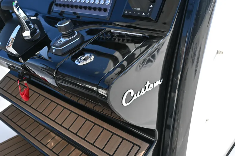 Slide: The Image of 2025 Tidewater 320 CC Adventure boat dashboard with custom controls and sleek design. - 17