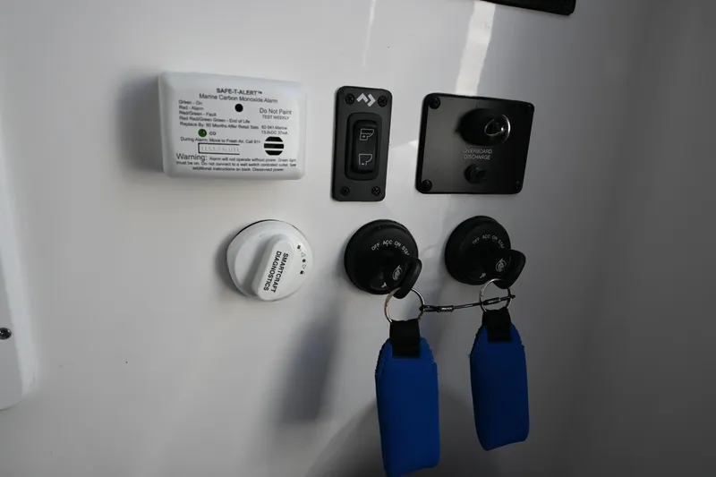 Slide: The Image of Control panel of 2025 Tidewater 320 CC Adventure boat with safety features and switches. - 23