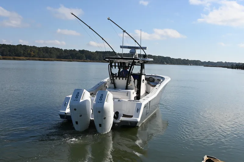 Slide: The Image of 2025 Tidewater 320 CC Adventure boat with dual 400 V10 engines on calm water. - 4