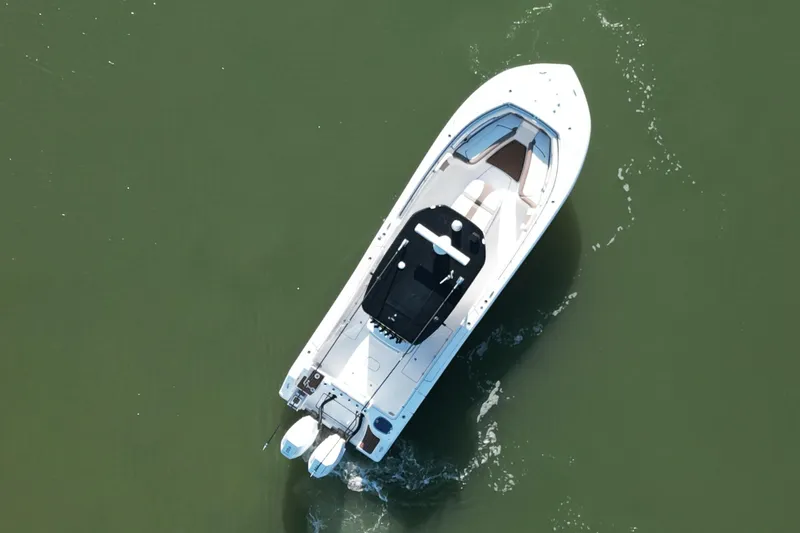 Slide: The Image of Aerial view of 2025 Tidewater 320 CC Adventure boat on calm water. - 6