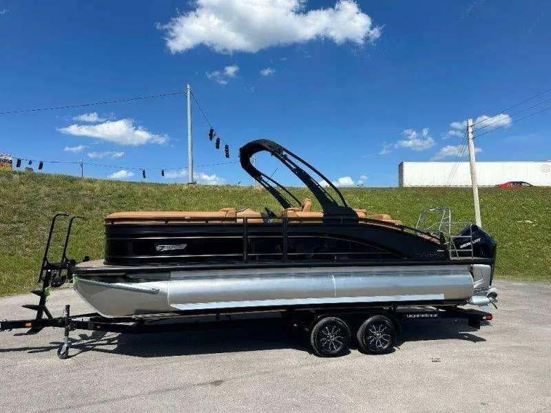 Slide: The Image of 2026 Harris Solstice 230 SL pontoon boat on trailer under blue sky. - 36