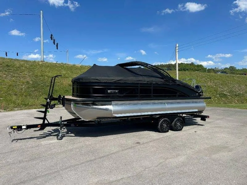 Slide: The Image of 2026 Harris Solstice 230 SL pontoon boat on trailer, blue sky. - 46