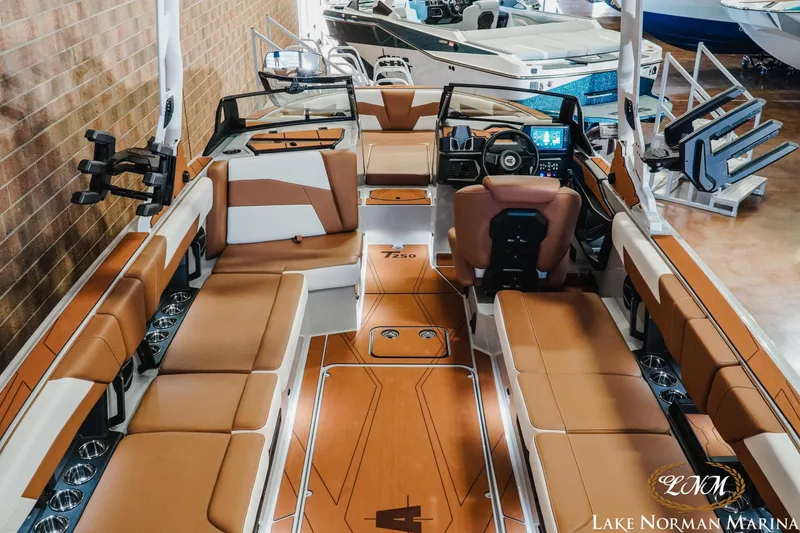 Slide: The Image of 2026 Axis T250 boat interior with tan seating and modern dashboard at Lake Norman Marina. - 12