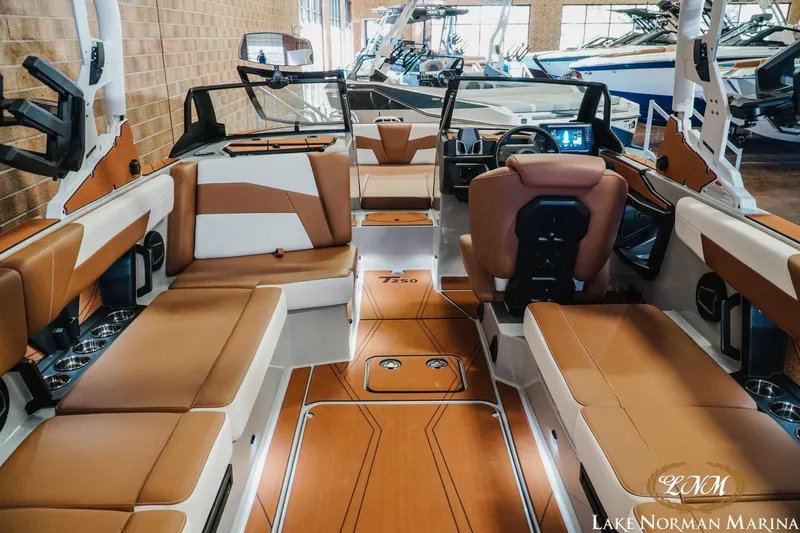 Slide: The Image of 2026 Axis T250 boat interior with luxurious brown and white seating at Lake Norman Marina. - 13