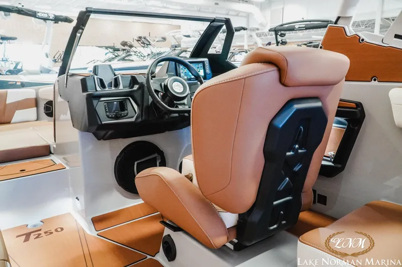 Slide: The Image of 2026 Axis T250 boat interior with tan seating and modern dashboard at Lake Norman Marina. - 14