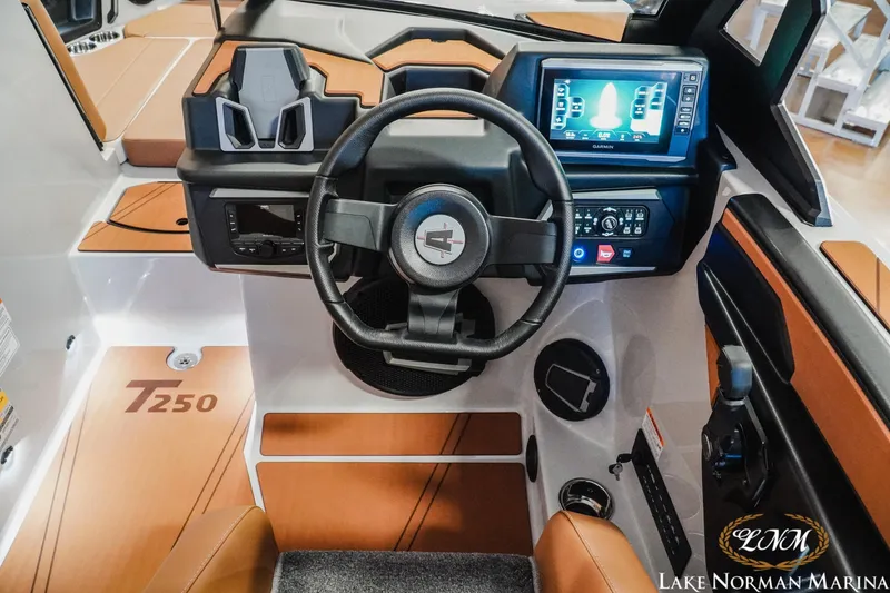 Slide: The Image of 2026 Axis T250 boat dashboard with steering wheel and digital display at Lake Norman Marina. - 15