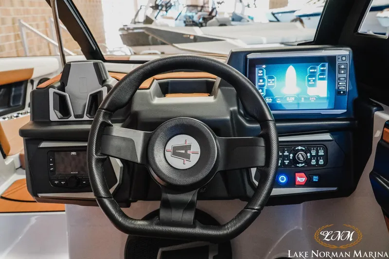 Slide: The Image of 2026 Axis T250 boat dashboard with steering wheel and digital display at Lake Norman Marina. - 22