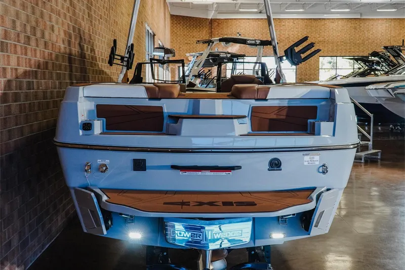 Slide: The Image of 2026 Axis T250 boat displayed indoors, showcasing rear design and features. - 8